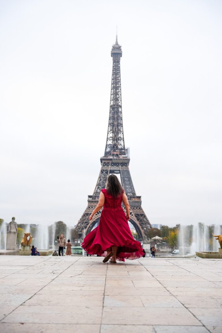 Woman in red walking towards Eiffel tower